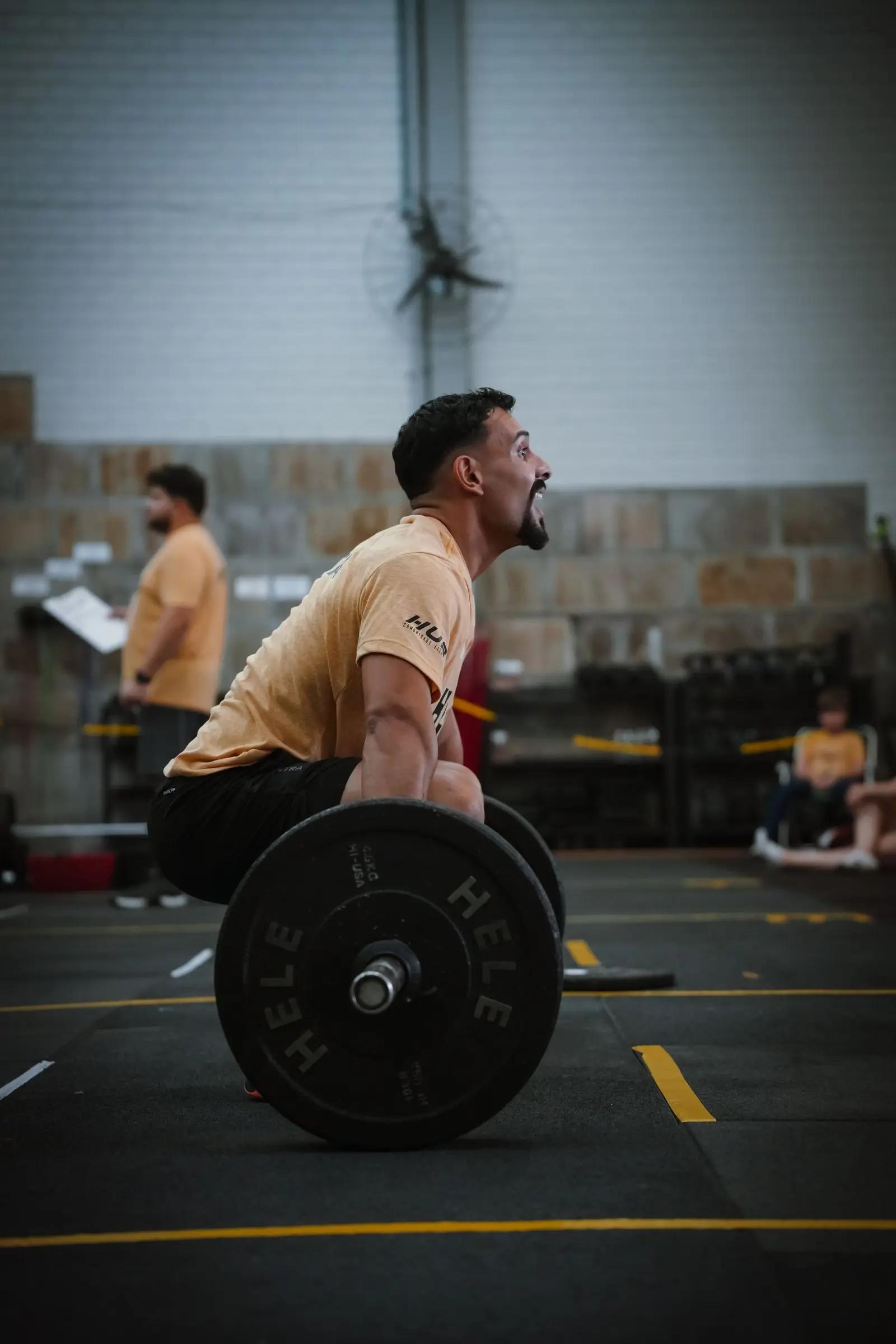 A man setting up for a deadlift in a gym