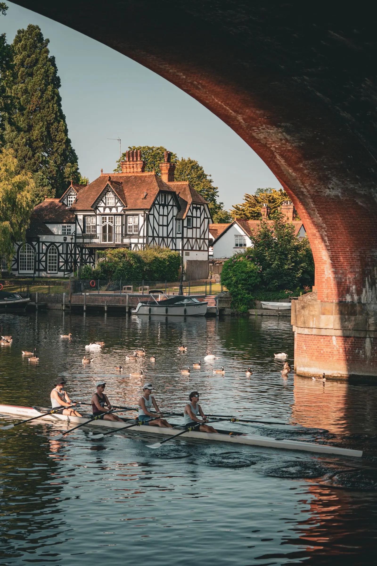 A rowing crew under a bridge on the Thames
